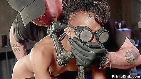 Slim Ebony Sub In Doggy Metal Device With Nikki Darling