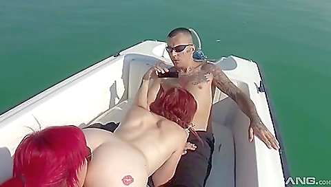 A sexy redhead with a tattoo gets fingered and cheek-punched