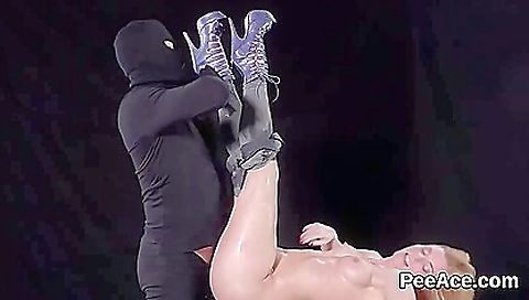 Blonde chick is fucking on the bed in the pissing pit